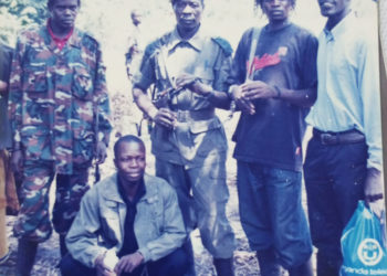 LRA fighters pose at Nabanga in north-western South Sudan in 2006 during confidence building for the peace talks. squatting is former Gulu Municipality MP David Oceng Penytoo, and journalist Sam Lawino (right). Photo by Sam Lawino.