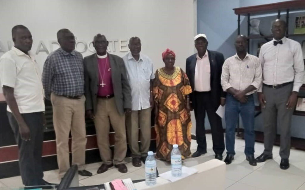 Legal team leader Francis Gimara (right) poses with a team of petitioners in Constitutional Court case on which the court ruled on February 20 that de-gazetted land that used to be owned by any customary owner or clan in the Acholi-sub-region be reverted to Acholi communities. COURTESY PHOTO.